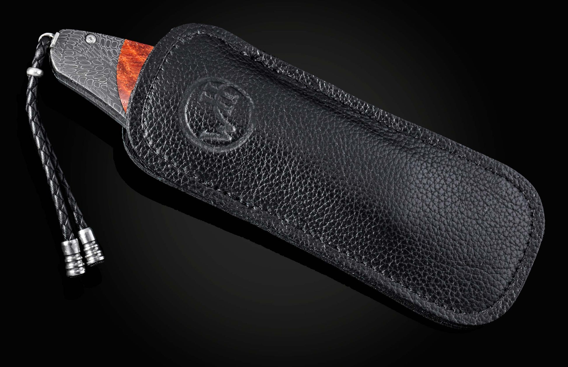 Black leather case with a lanyard on a dark background