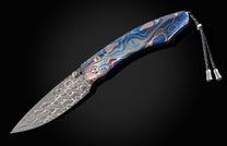 Folding knife with a decorative handle on a black background