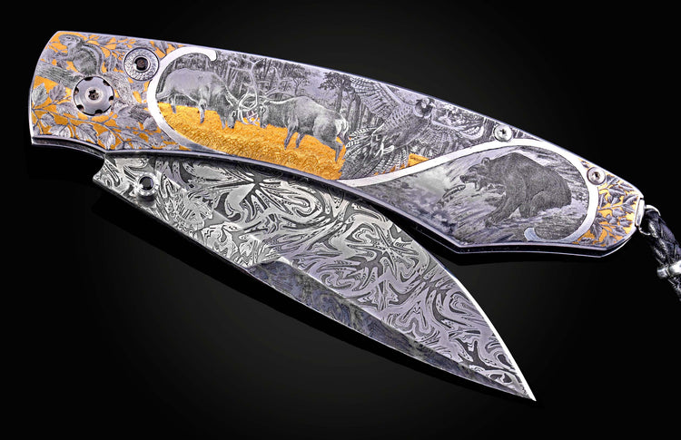Hand engraved William Henry knife depicting anmals