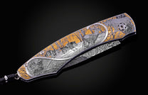 Hand engraved William Henry knife depicting anmals