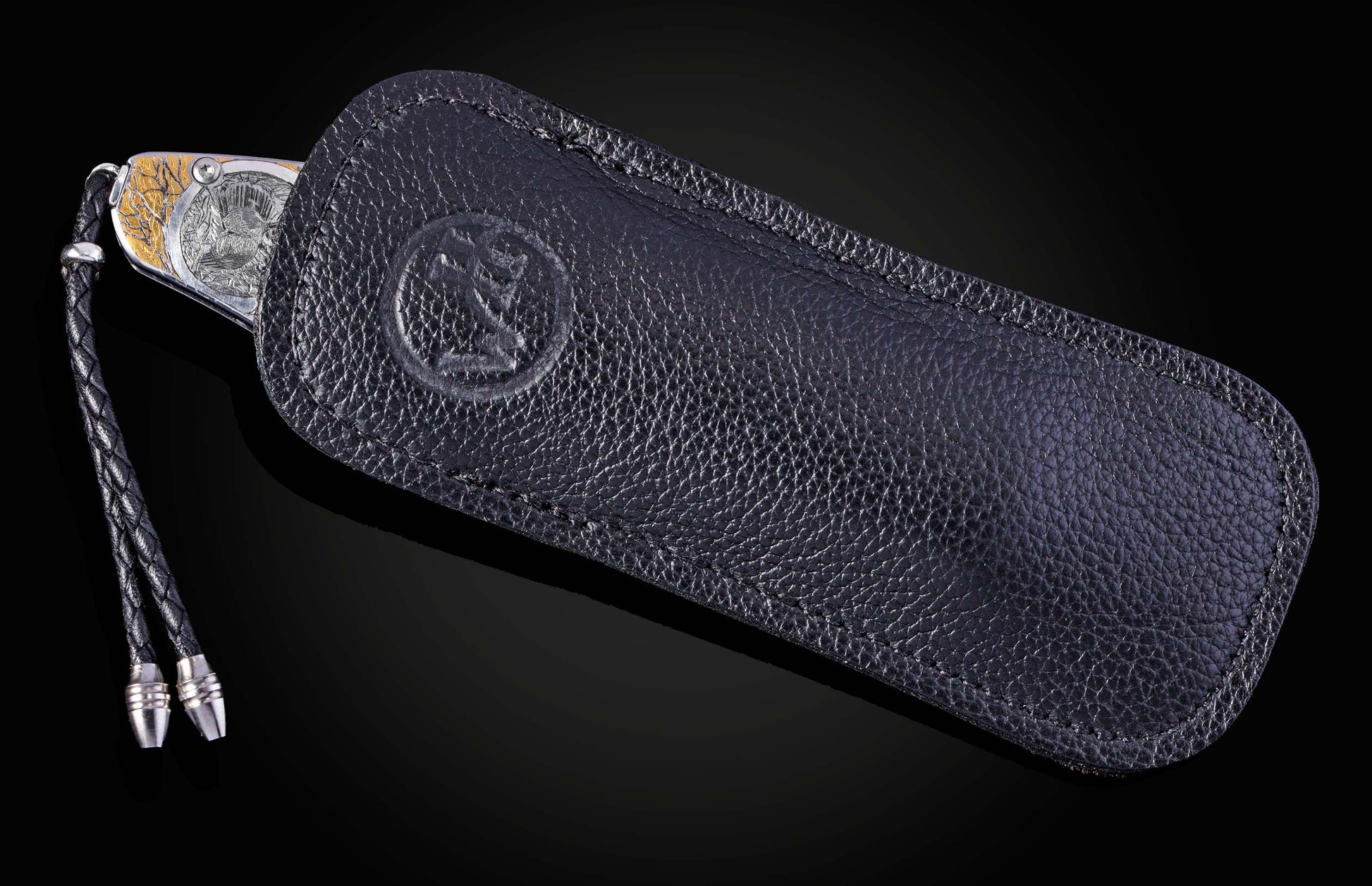 Hand engraved William Henry knife depicting anmals