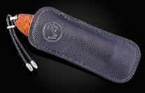 Black leather case with a wooden handle on a black background