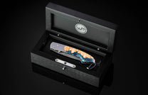 William Henry knife with a damascus steel blade and shockwood handle in a display box