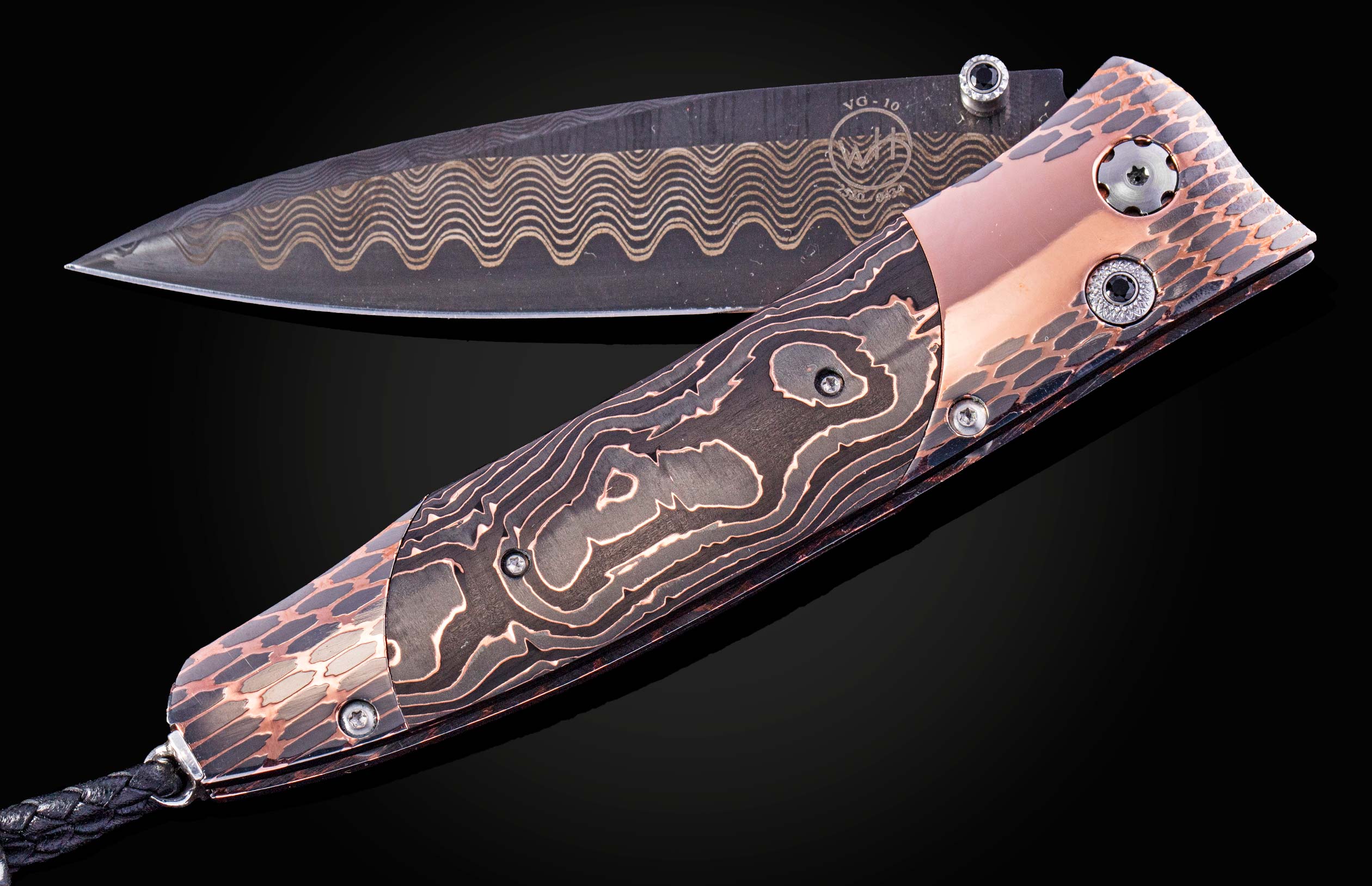 William Henry knife featuring coper & carbon fiber scales and a superconductor frame