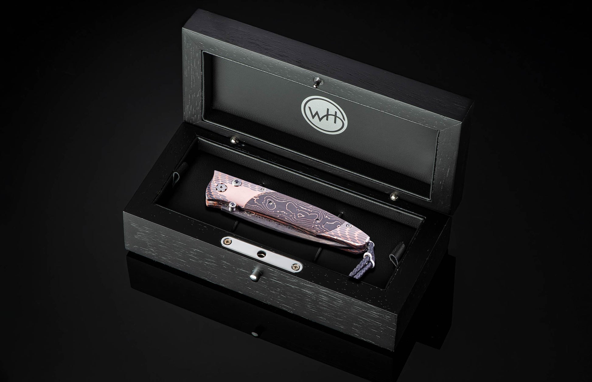 William Henry knife featuring coper & carbon fiber scales and a superconductor frame