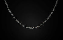 Black Box Chain men's jewelry from William Henry is bronze with black PVD coating for easy care and durability. The chain is displayed on a black background.