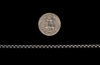 Black Box Chain men's jewelry from William Henry is bronze with black PVD coating for easy care and durability. Image shows the Black Box Chain next to a U.S. quarter as a size reference.