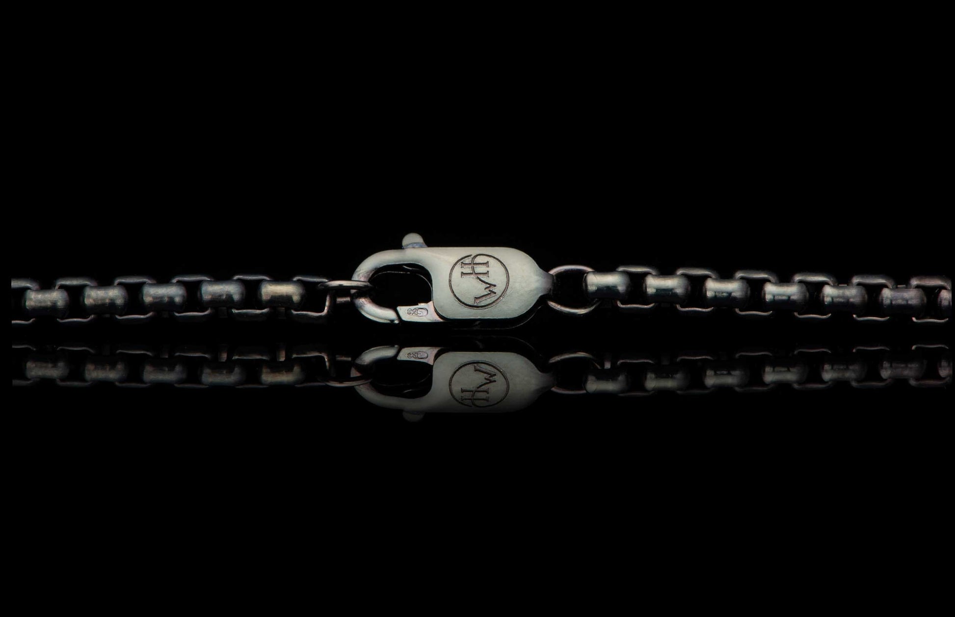 Black Box Chain men's jewelry from William Henry is bronze with black PVD coating for easy care and durability. Image is a detail photo showing the custom William Henry latch.