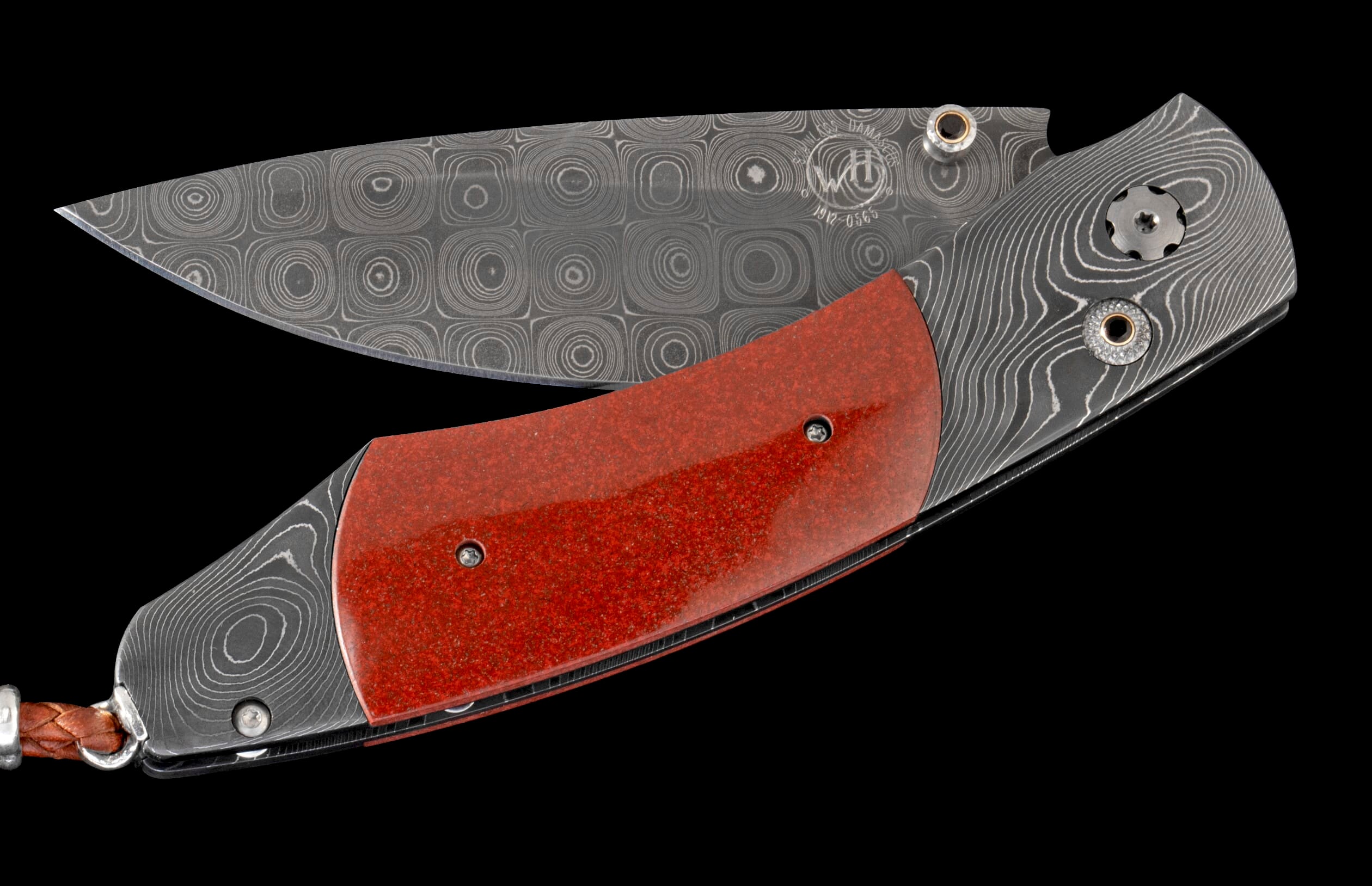Open folding knife with a target-patterned Damascus blade, textured red handle, wavy Damascus bolsters, and a brown leather lanyard.