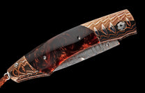 Folding knife, closed, with dark reddish-brown glitter handle, copper and silver Damascus patterned bolsters, and a braided leather lanyard.
