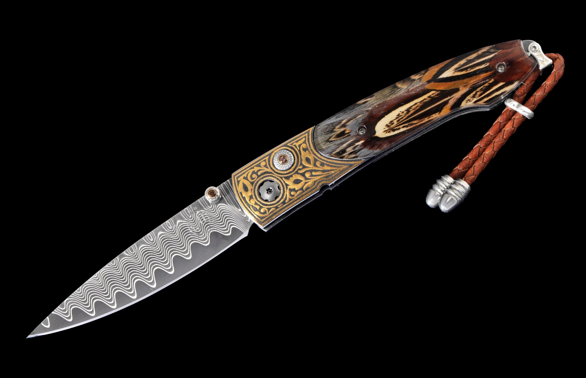 Decorative folding knife with a wavy Damascus blade, gold engraved frame, feather handle scales, and a braided leather lanyard with silver beads.