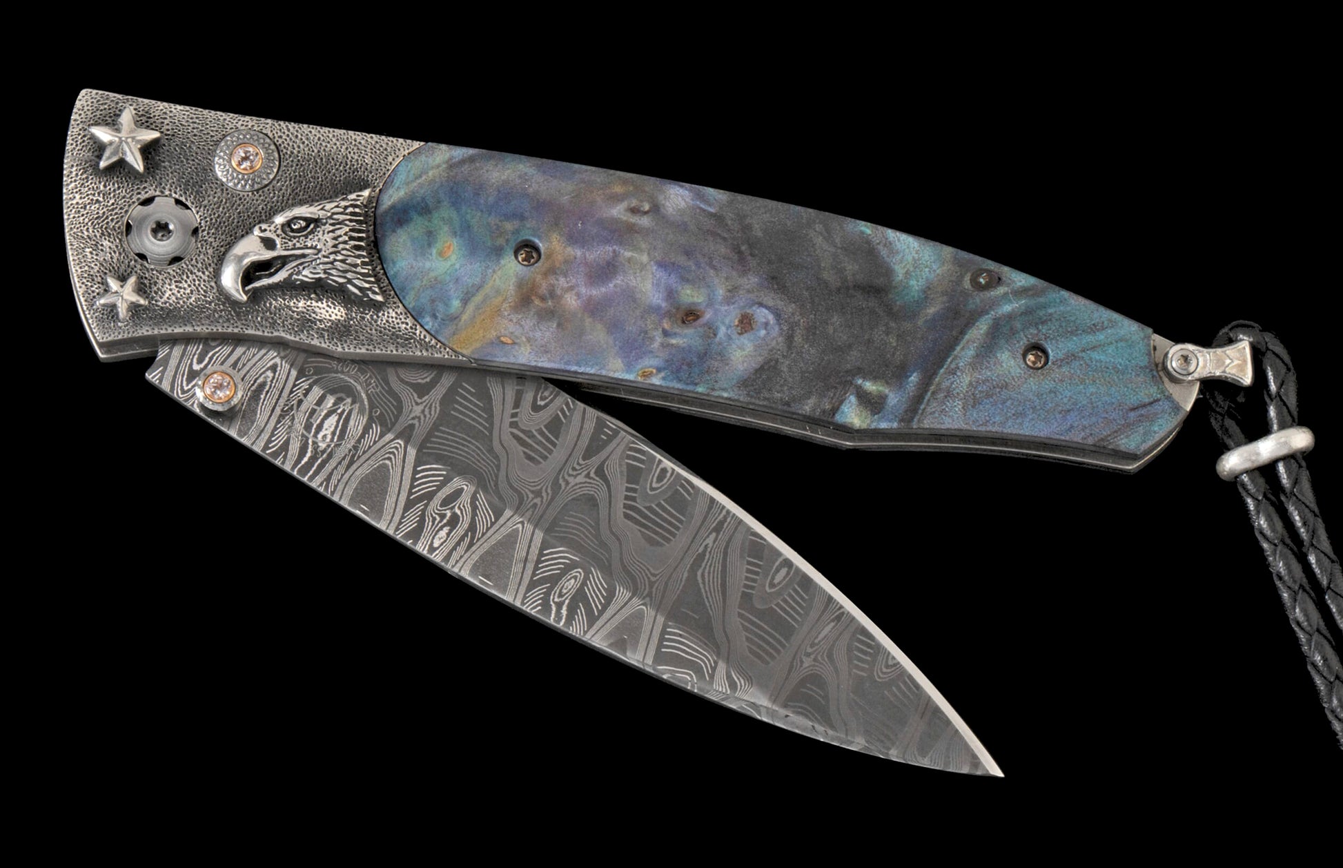 Partially open folding knife with a silver Damascus blade and iridescent blue-green abalone handle, featuring an eagle, stars, and small brown gems.