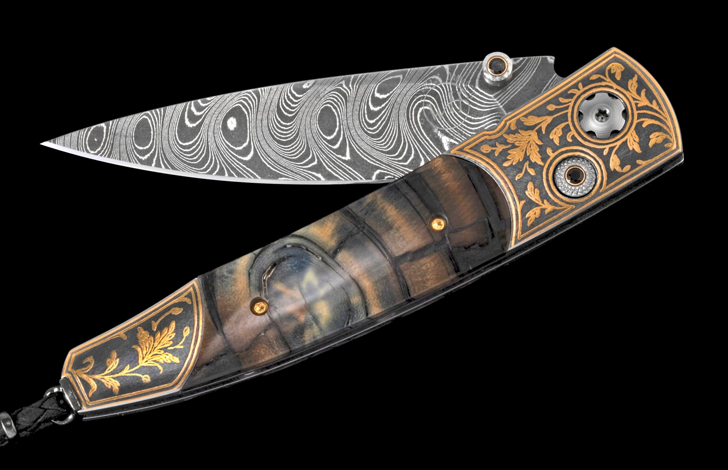 Ornate folding knife with Damascus blade and dark handle featuring golden leaf engraving and a black lanyard.