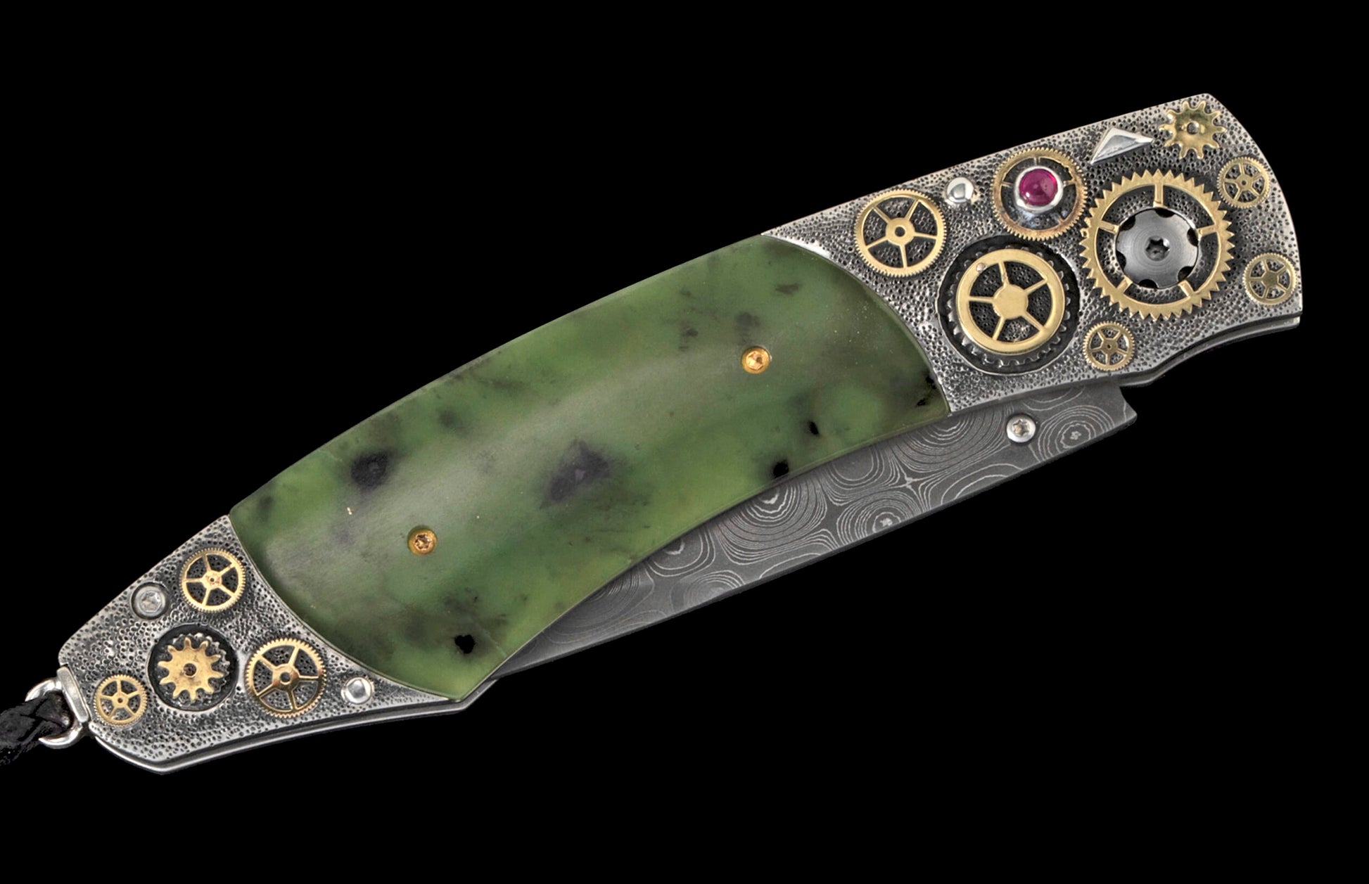 Folding knife with a green jade handle, silver-toned metal featuring gold gears and a ruby, and a Damascus steel blade.