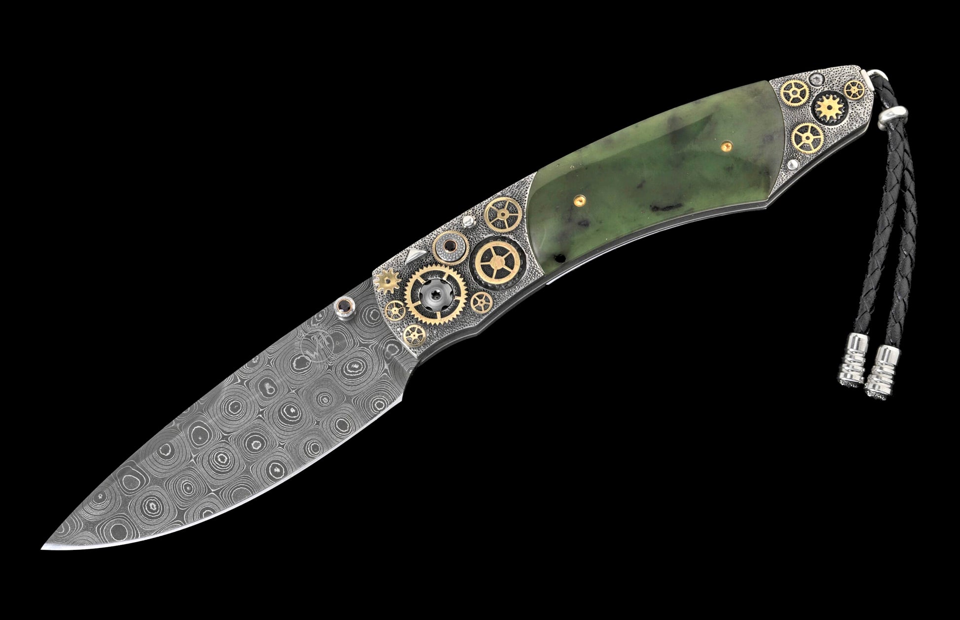 A custom folding knife with a Damascus steel blade and green jade handle, decorated with brass gears and textured silver metal, featuring a black braided leather lanyard.