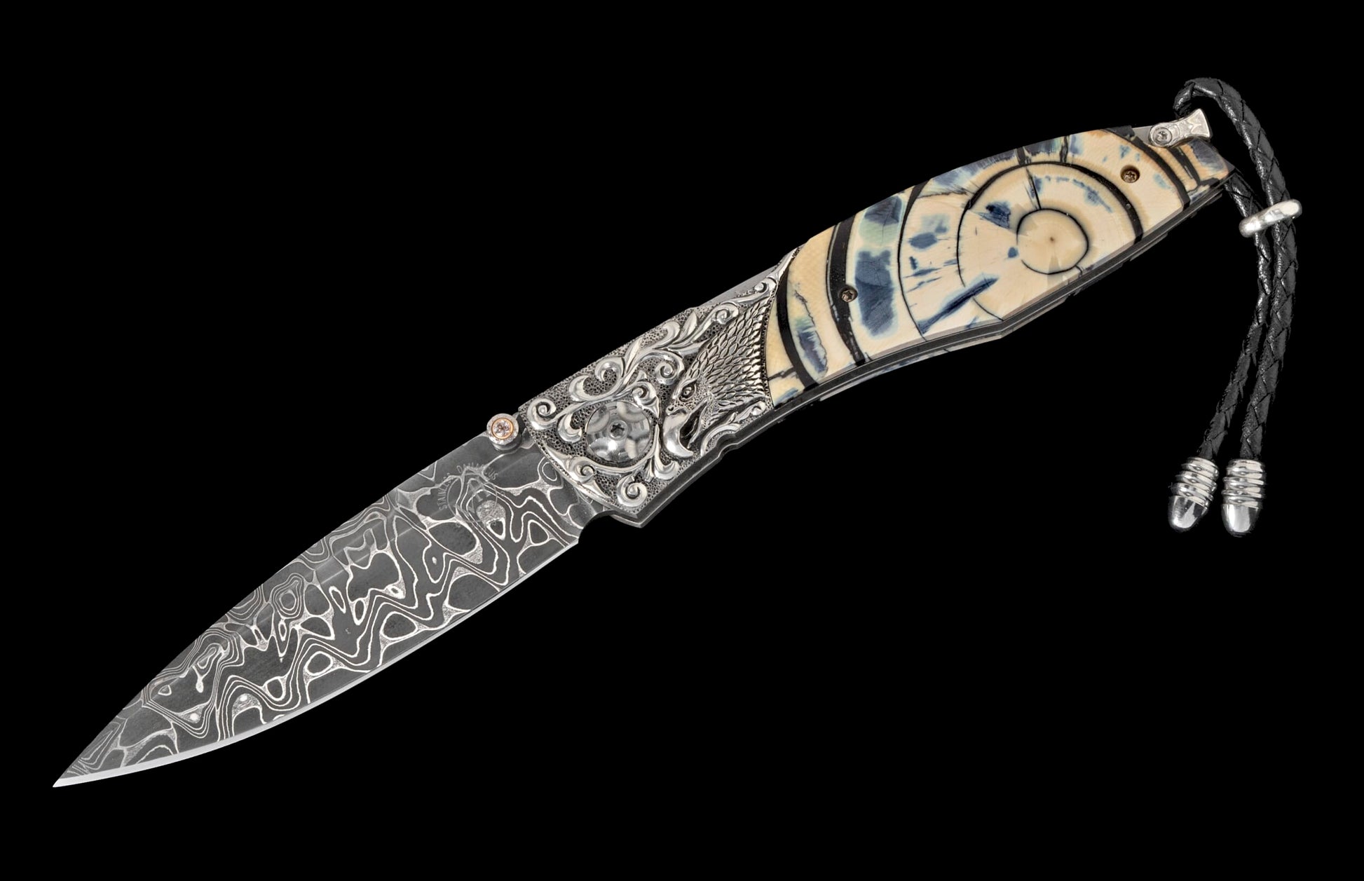 Damascus folding knife with carved eagle head silver bolster, patterned ivory handle, and black leather lanyard.
