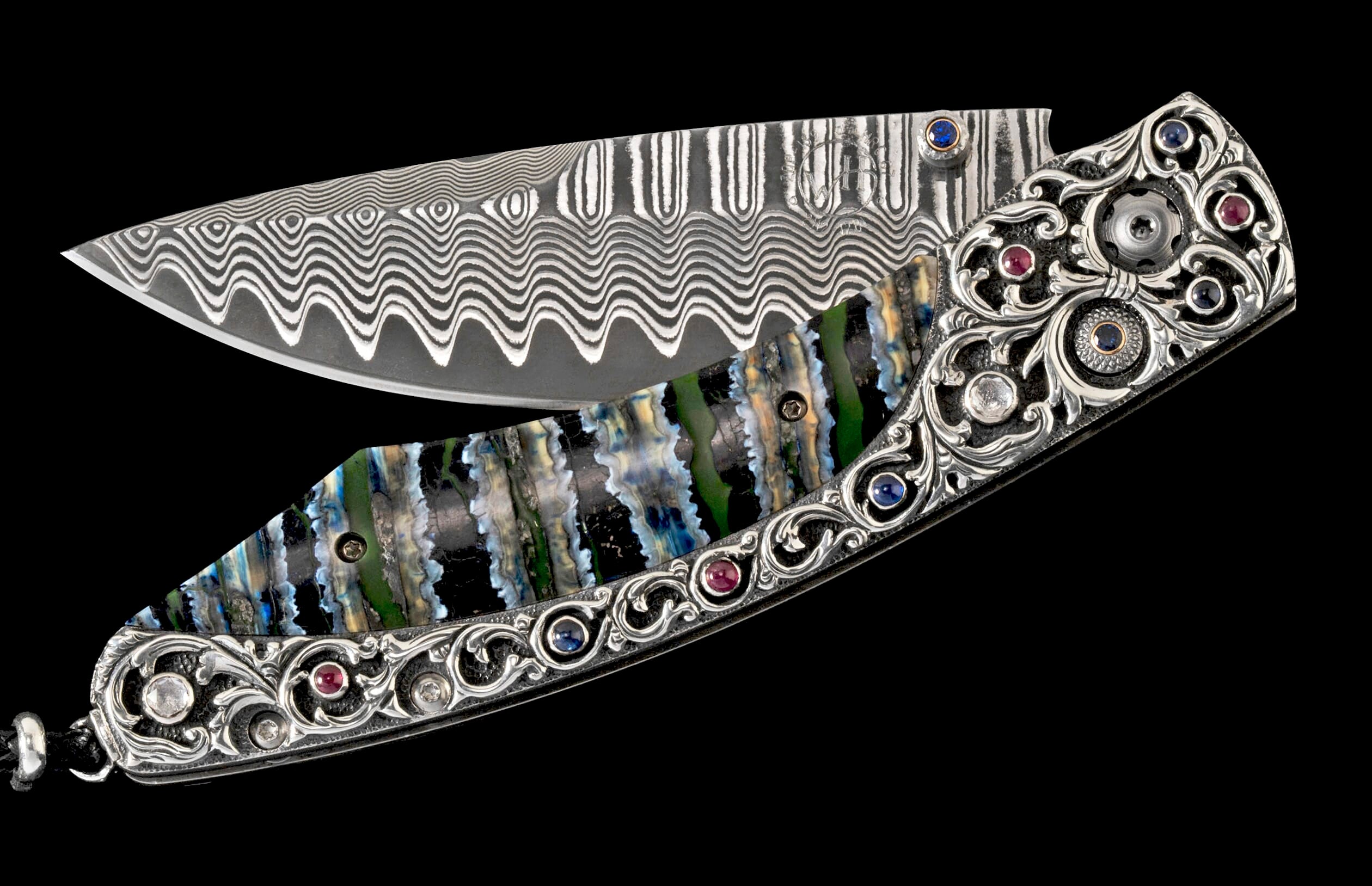 Folding knife with wavy Damascus steel blade, ornate silver handle, colorful striped inlay, and gemstone accents.