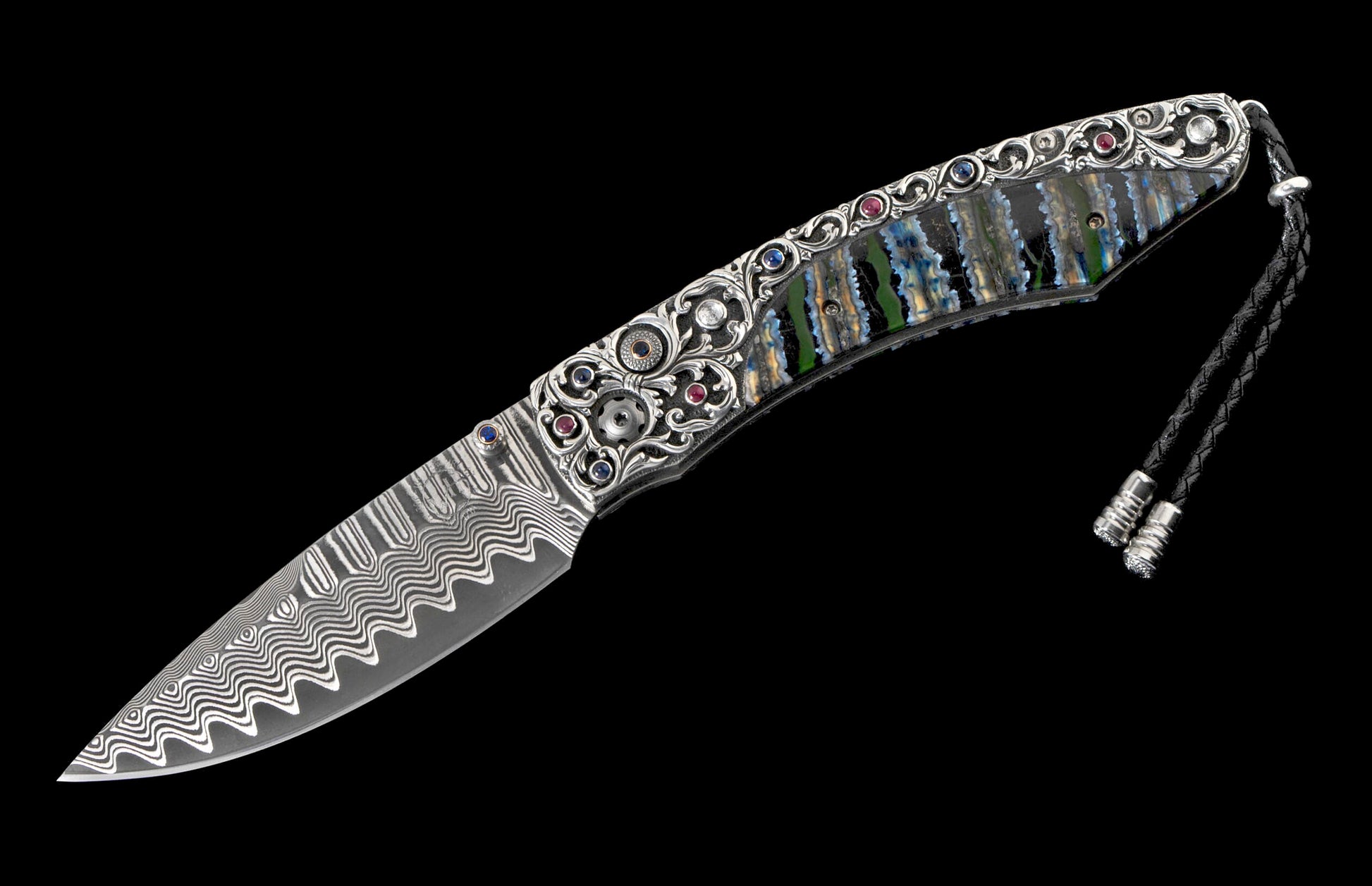Ornate knife with a wavy Damascus steel blade and an intricately decorated handle featuring silver scrollwork, colorful gemstones, and iridescent shell panels.