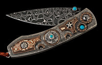 Decorative folding knife with Damascus blade, textured silver handle, turquoise inlays, patterned copper elements, and a brown leather lanyard.