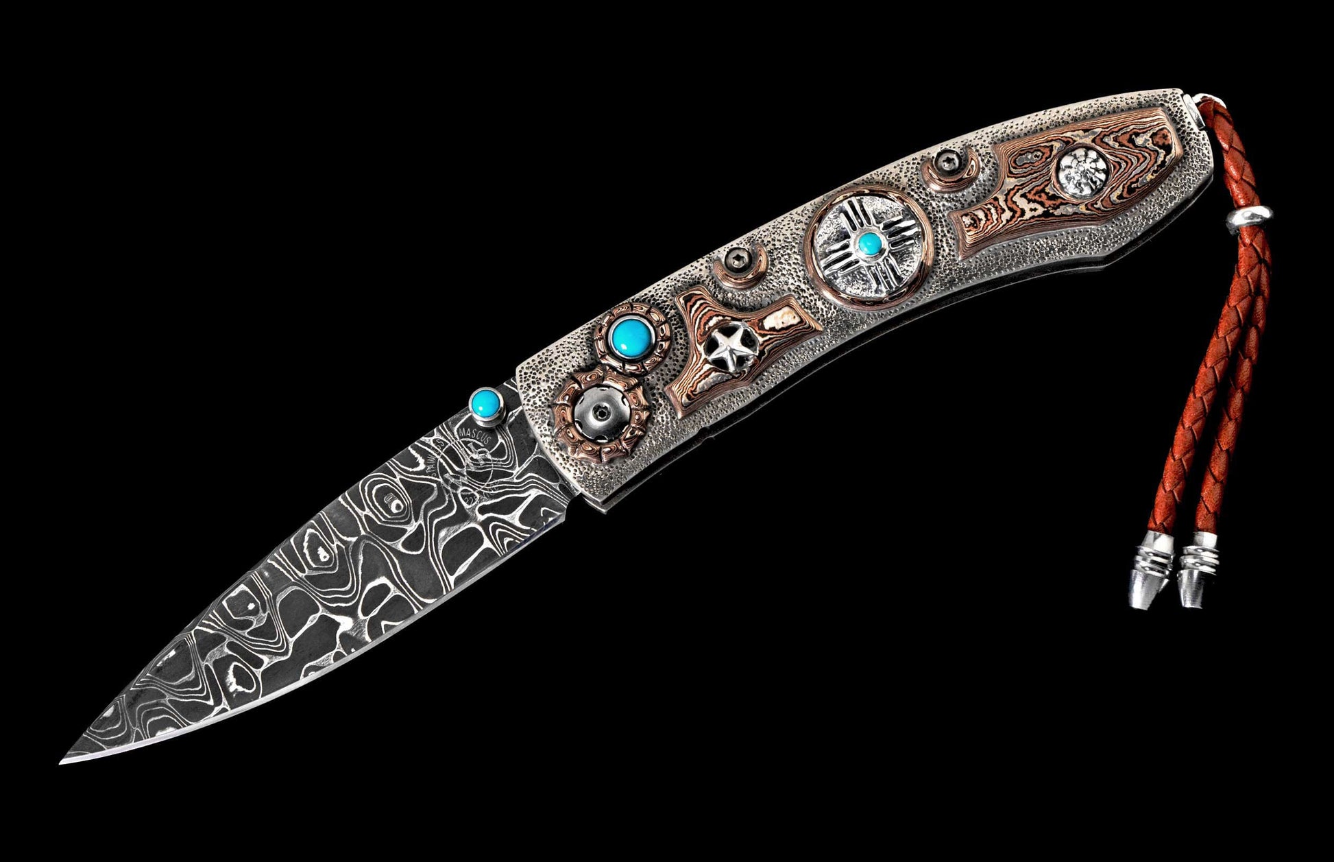Ornate knife with Damascus steel blade and intricate metal handle adorned with turquoise, copper inlays, and a brown braided leather lanyard.