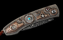 Decorative folding knife with a textured silver handle featuring copper accents, striped inlays, turquoise and red stones, and a visible Damascus steel blade.