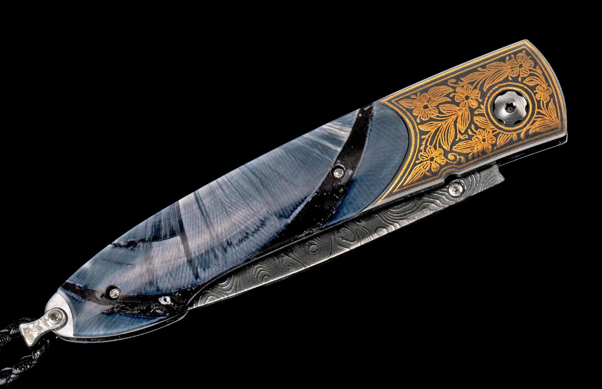 Ornate folding knife with a blue-gray swirling handle, intricate gold floral engravings, and Damascus steel details.