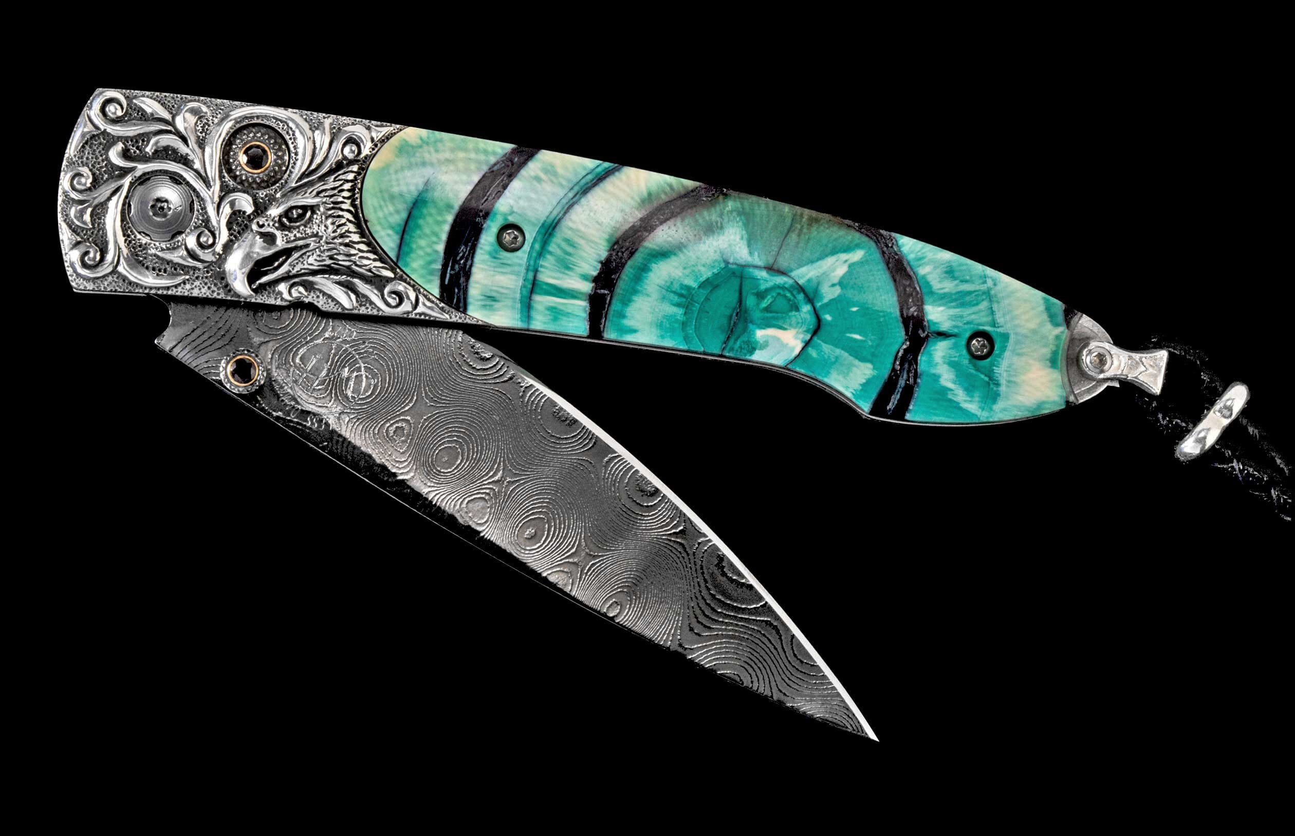 Folding knife, blade partially open, with a turquoise and black striped handle, detailed silver eagle head bolster, and swirled Damascus steel blade.