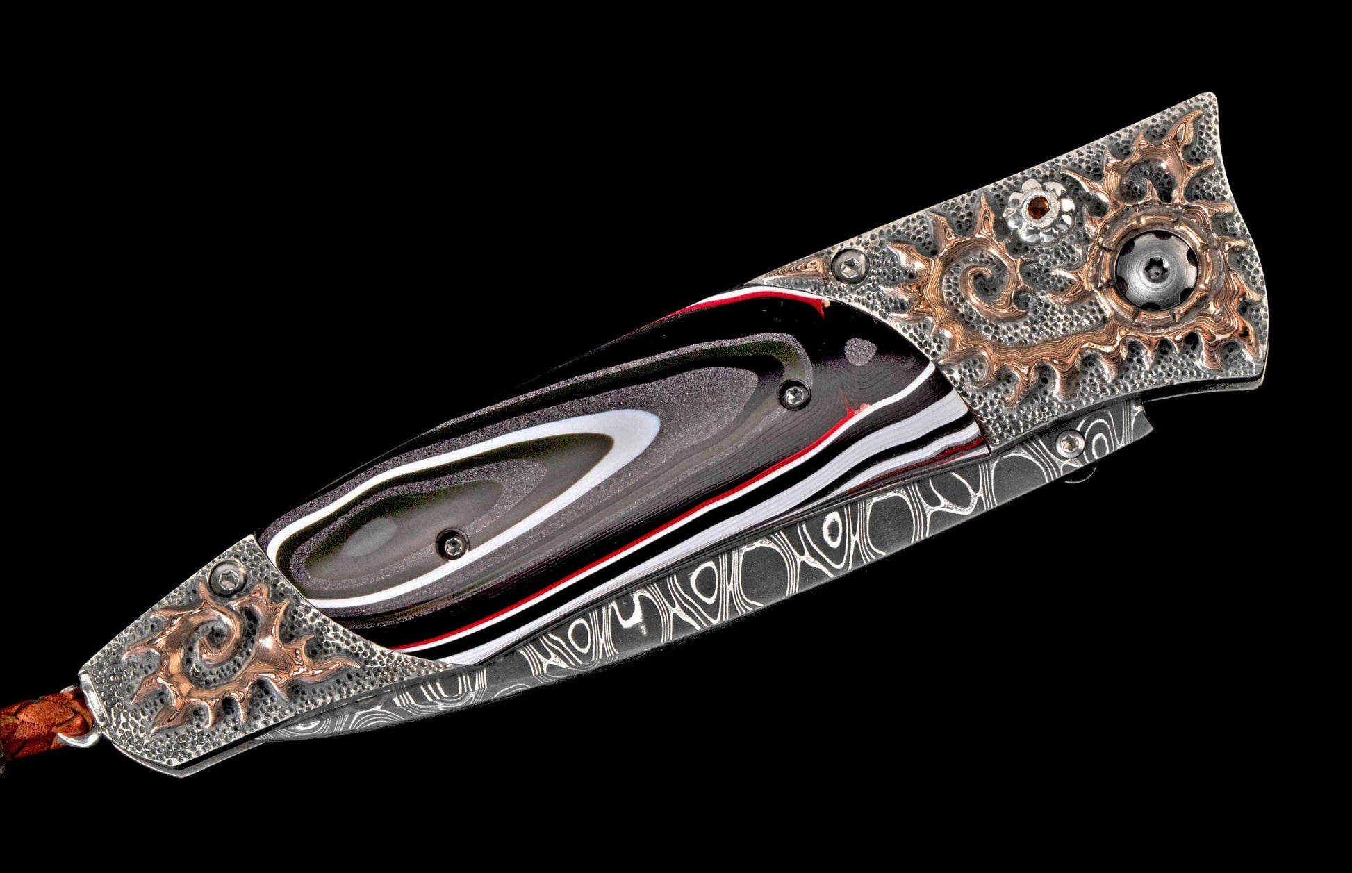 Ornate folding knife with black, white, and red layered handle, silver-toned bolster with copper scrollwork, and a visible Damascus blade.