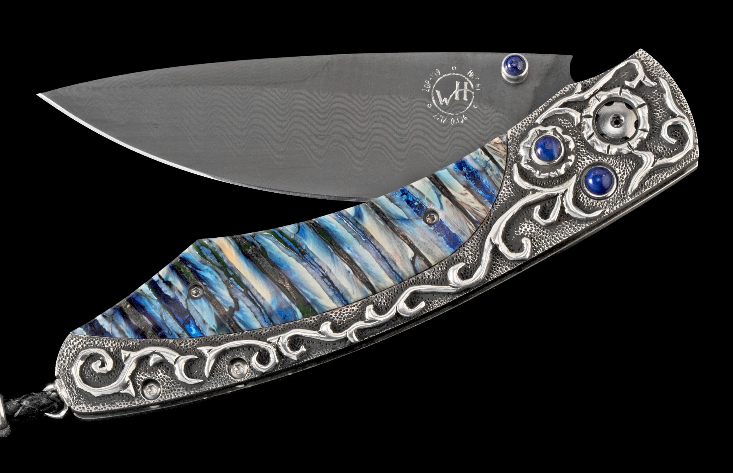 Ornate folding knife featuring a Damascus blade, blue and white handle, and silver scrollwork with lapis lazuli.