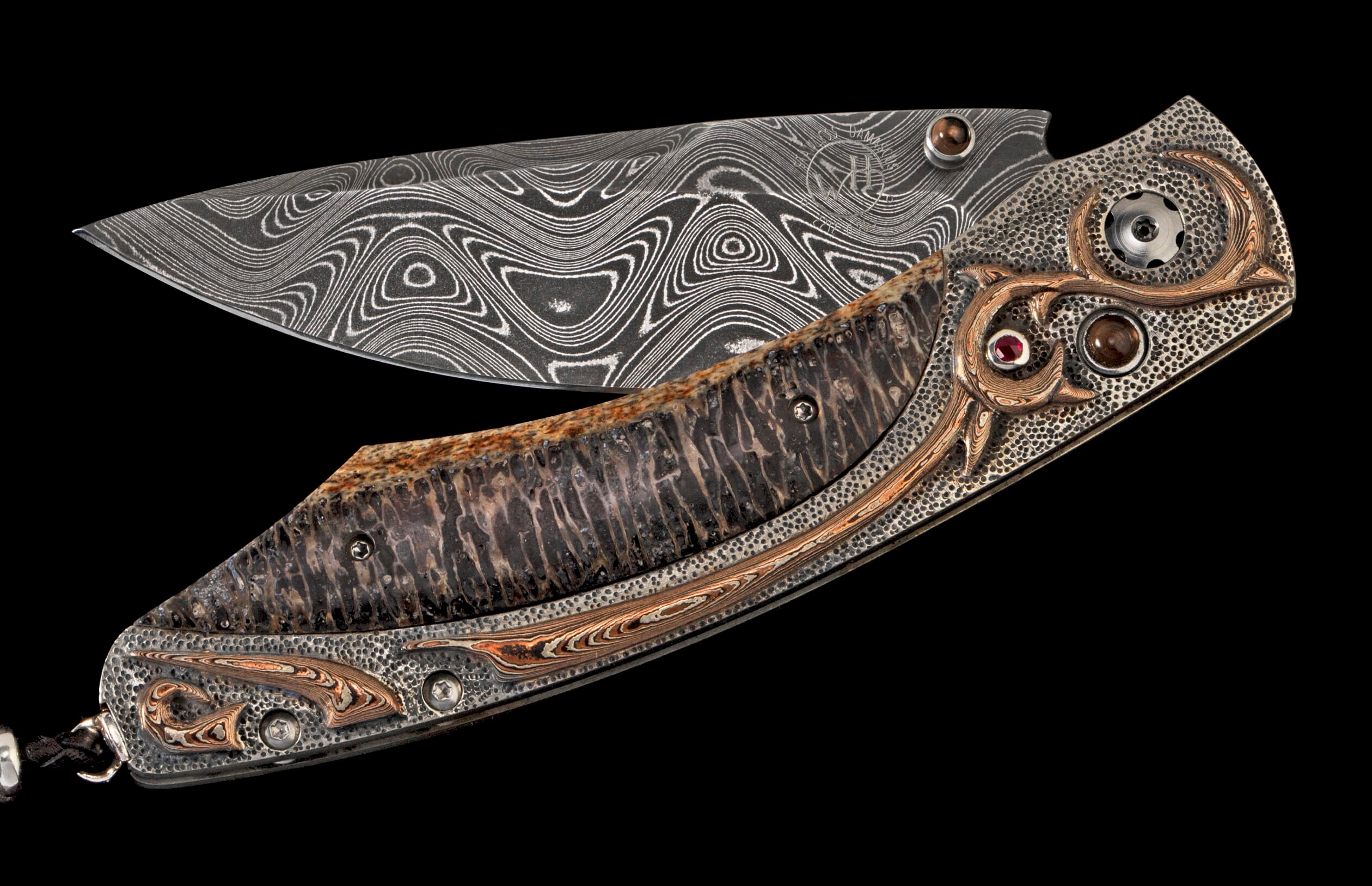 Ornate folding knife with wavy Damascus blade, textured handle, and decorative silver, copper, and gemstone accents.