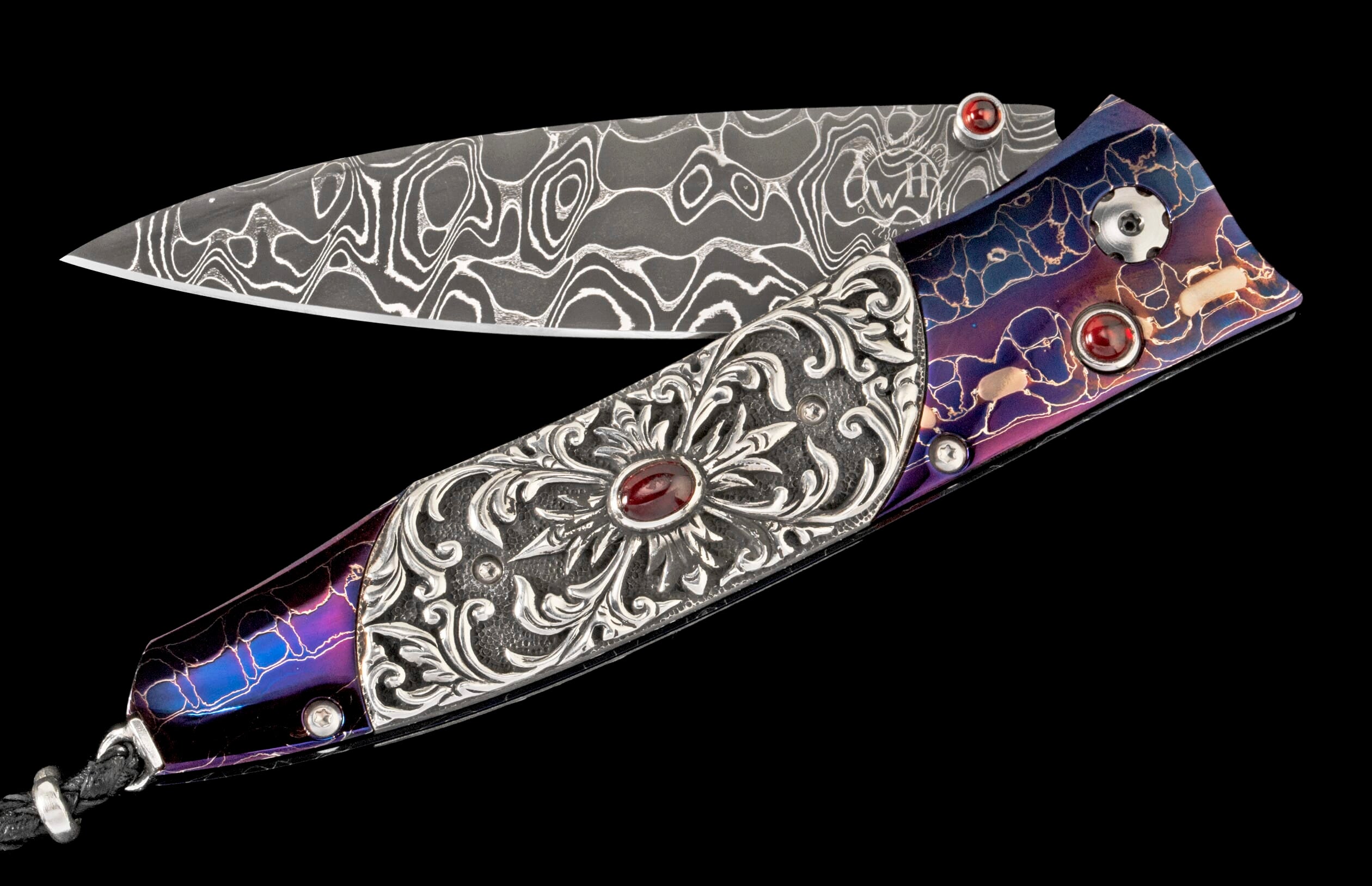 Open knife with a patterned Damascus blade, ornate silver handle with a red gem, and iridescent blue-purple accents.
