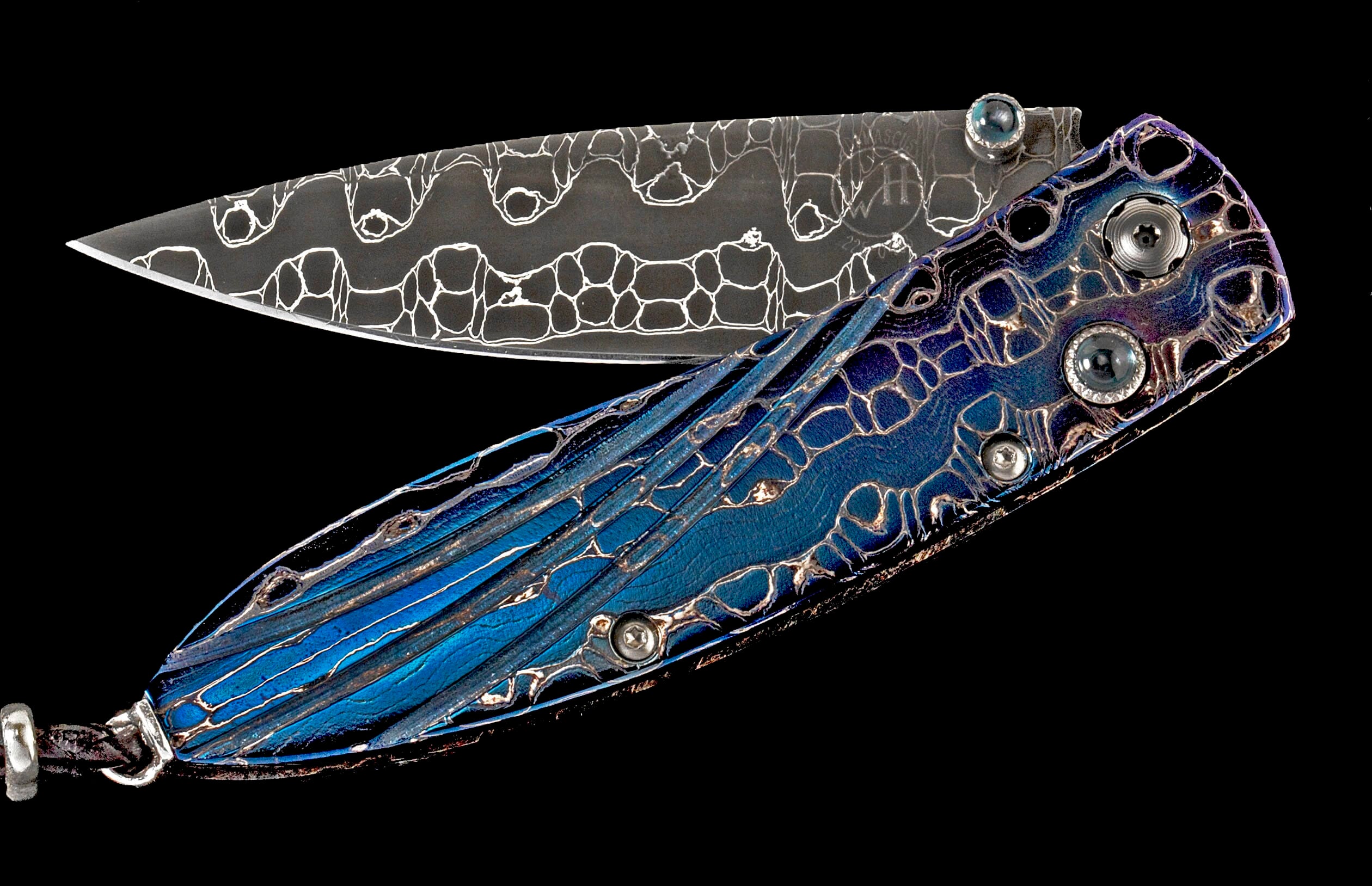 Partially open knife with an iridescent blue handle and a Damascus blade featuring an organic, cellular pattern.