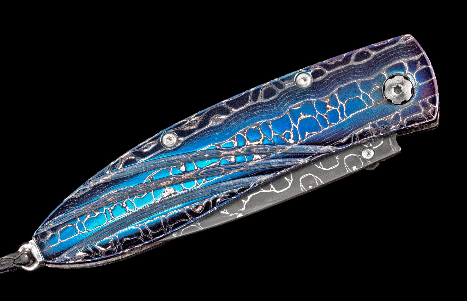 Iridescent blue and purple metallic folding knife with an organic crackle pattern, exposed screws, and a lanyard hole.
