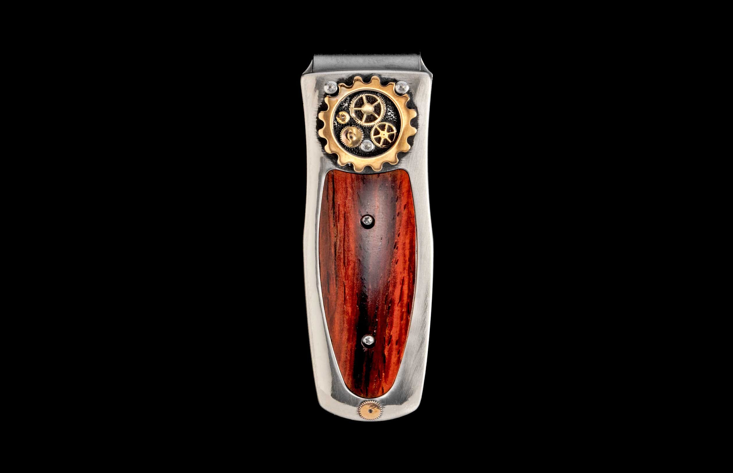 Steampunk money clip featuring silver metal, intricate gold gears, and a rich reddish-brown wood inlay.