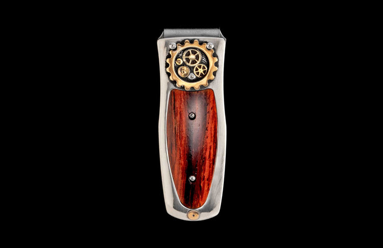 Steampunk money clip featuring silver metal, intricate gold gears, and a rich reddish-brown wood inlay.
