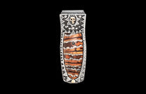 Silver-tone money clip featuring a layered brown and orange stone inlay, studded with white gems and a gold skull.