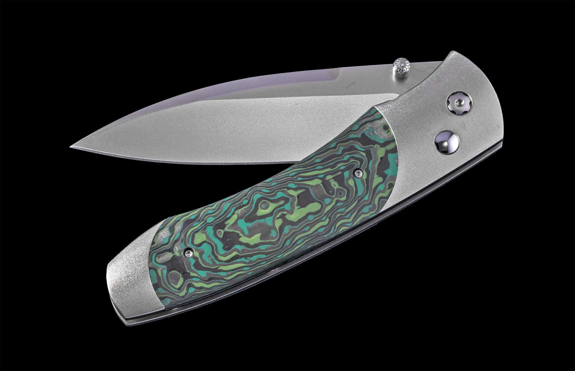 Folding knife with a decorative handle on a black background