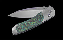 Folding knife with a decorative handle on a black background