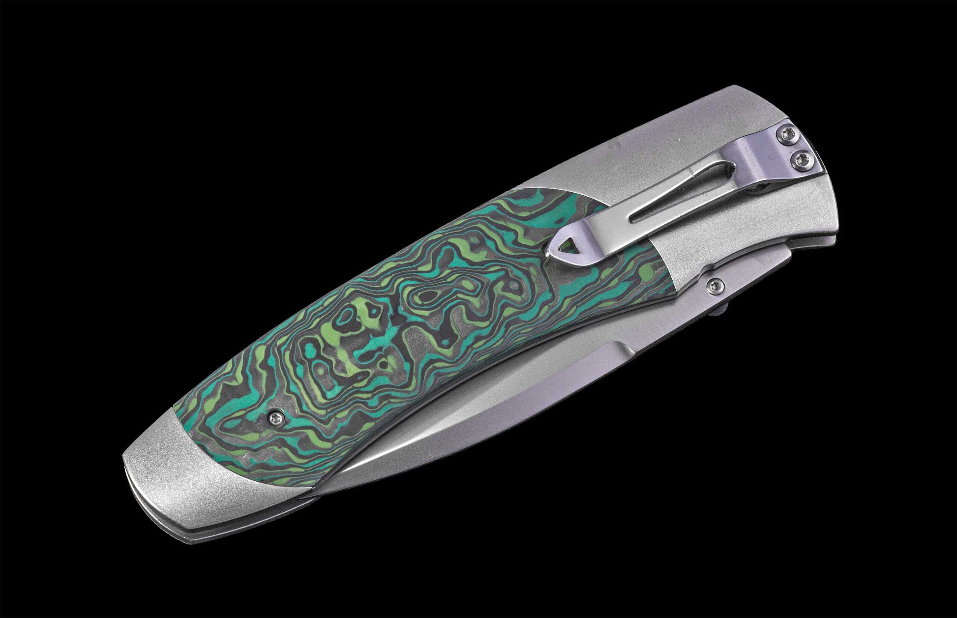 Foldable knife with green patterned handle on a black background