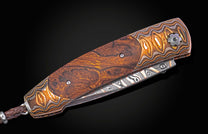 Folding knife with decorative handle and blade on a black background