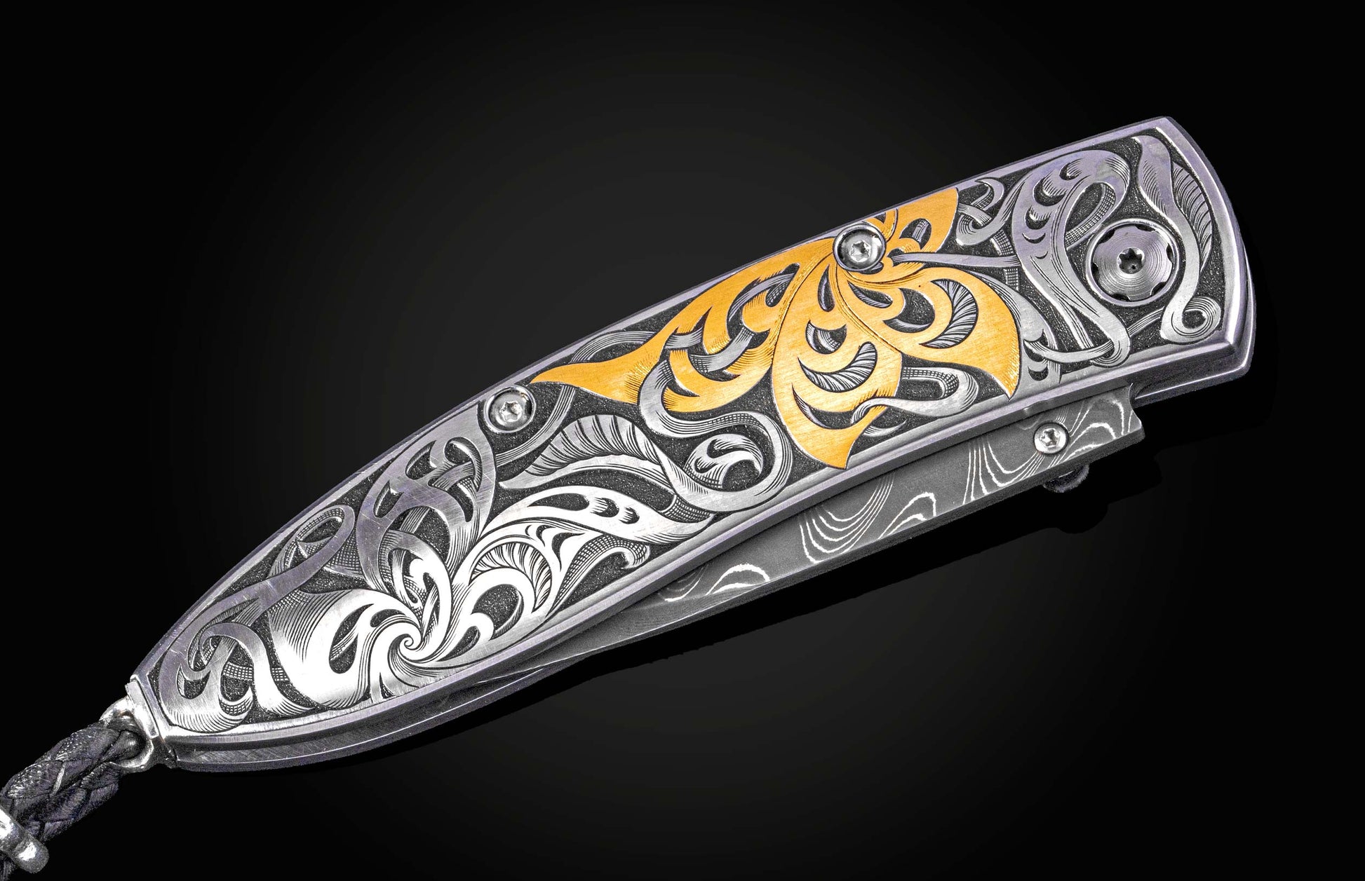 Hand engraved William Henry knife with 24k gold inlays and damascus steel blade