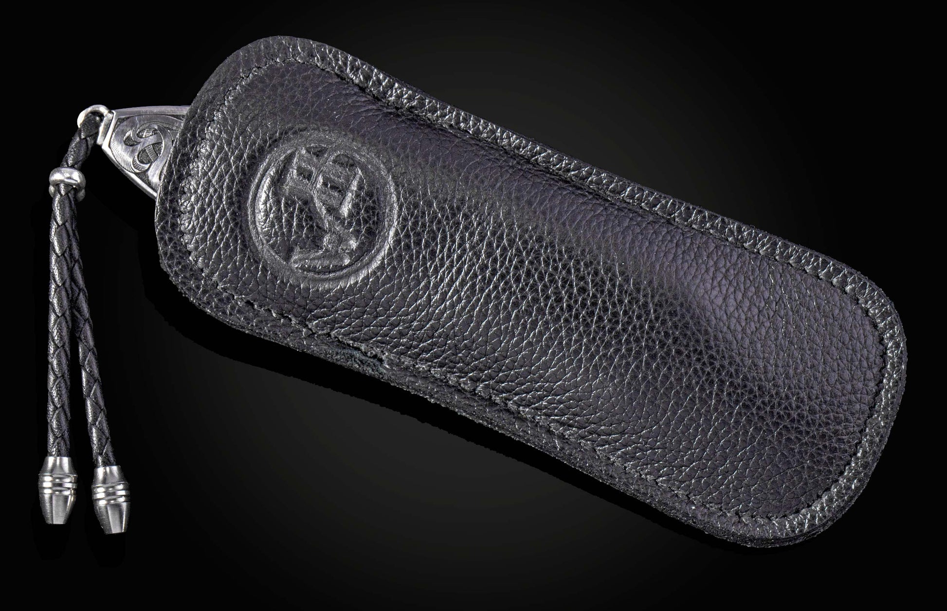 Hand engraved William Henry knife in black leather case