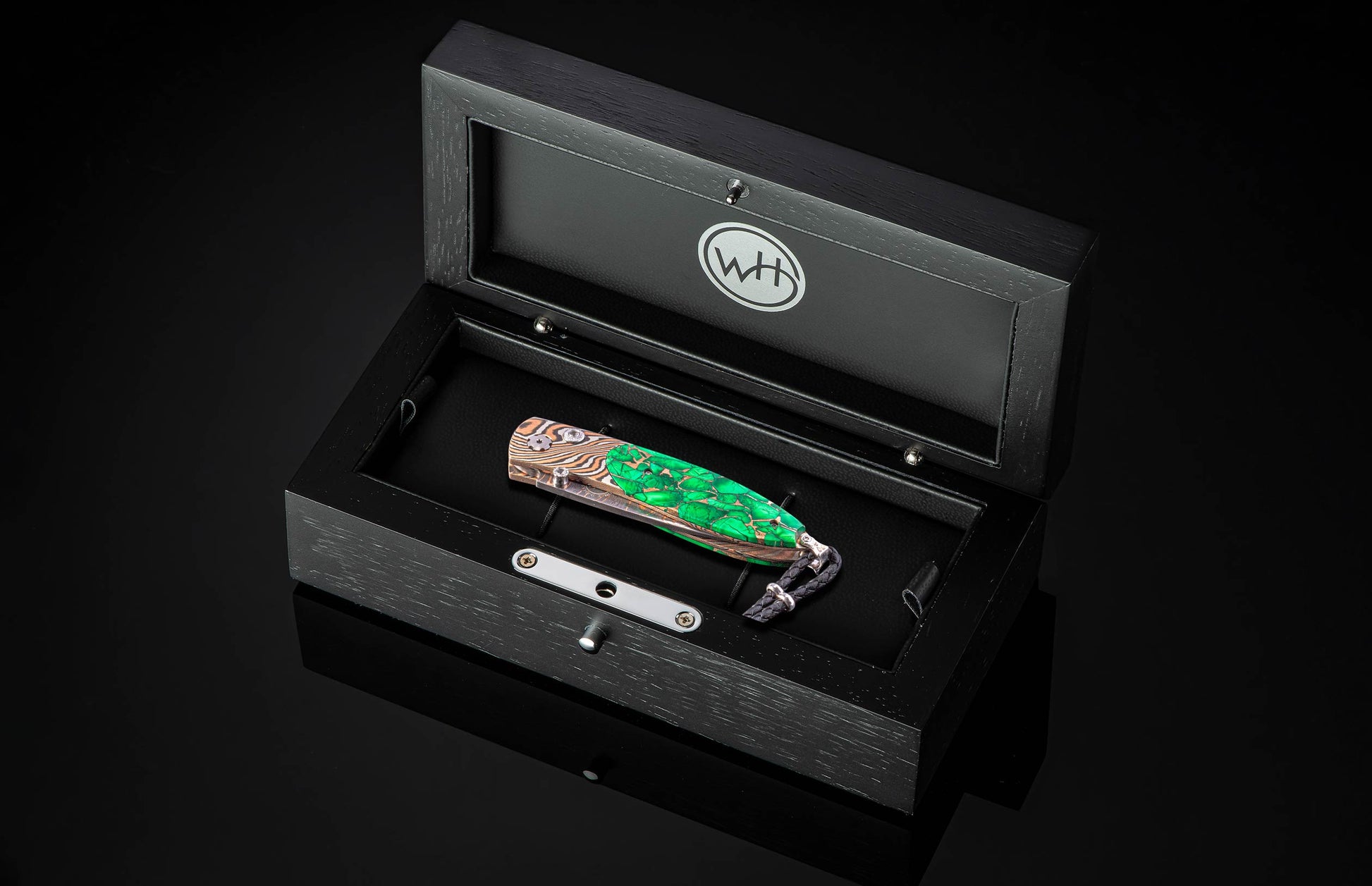 William Henry folding knife with mokume gane and Irish Green Stone in a wooden display case