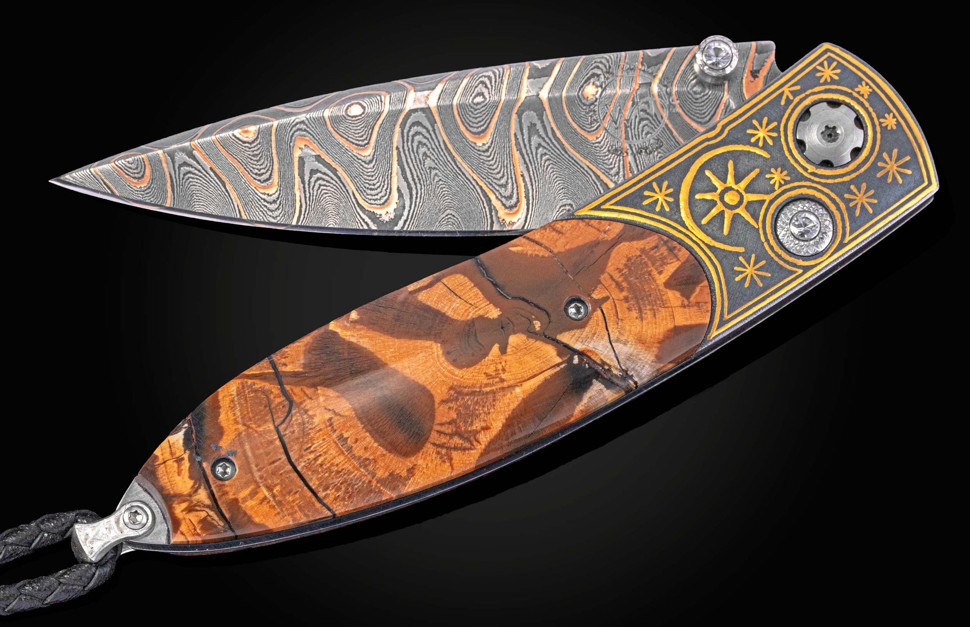 Folding knife with inlaid gold designs and mammoth tusk handle on a black background with blade part open