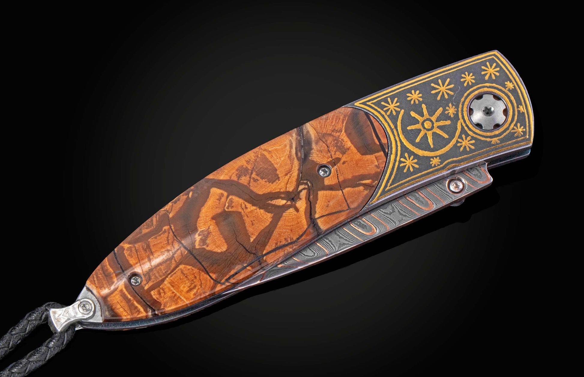 Folding knife with inlaid gold designs and mammoth tusk handle on a black background with blade closed