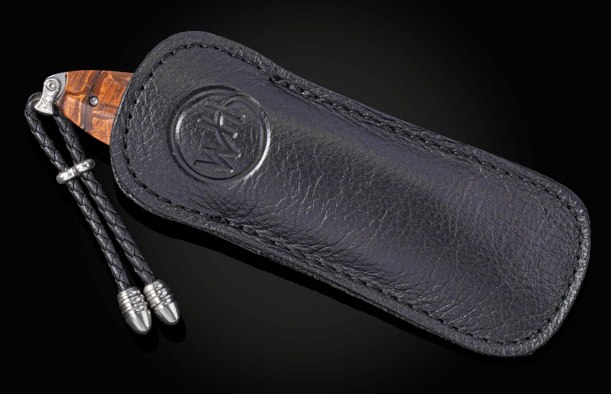 Black leather sheath with knife on a black background