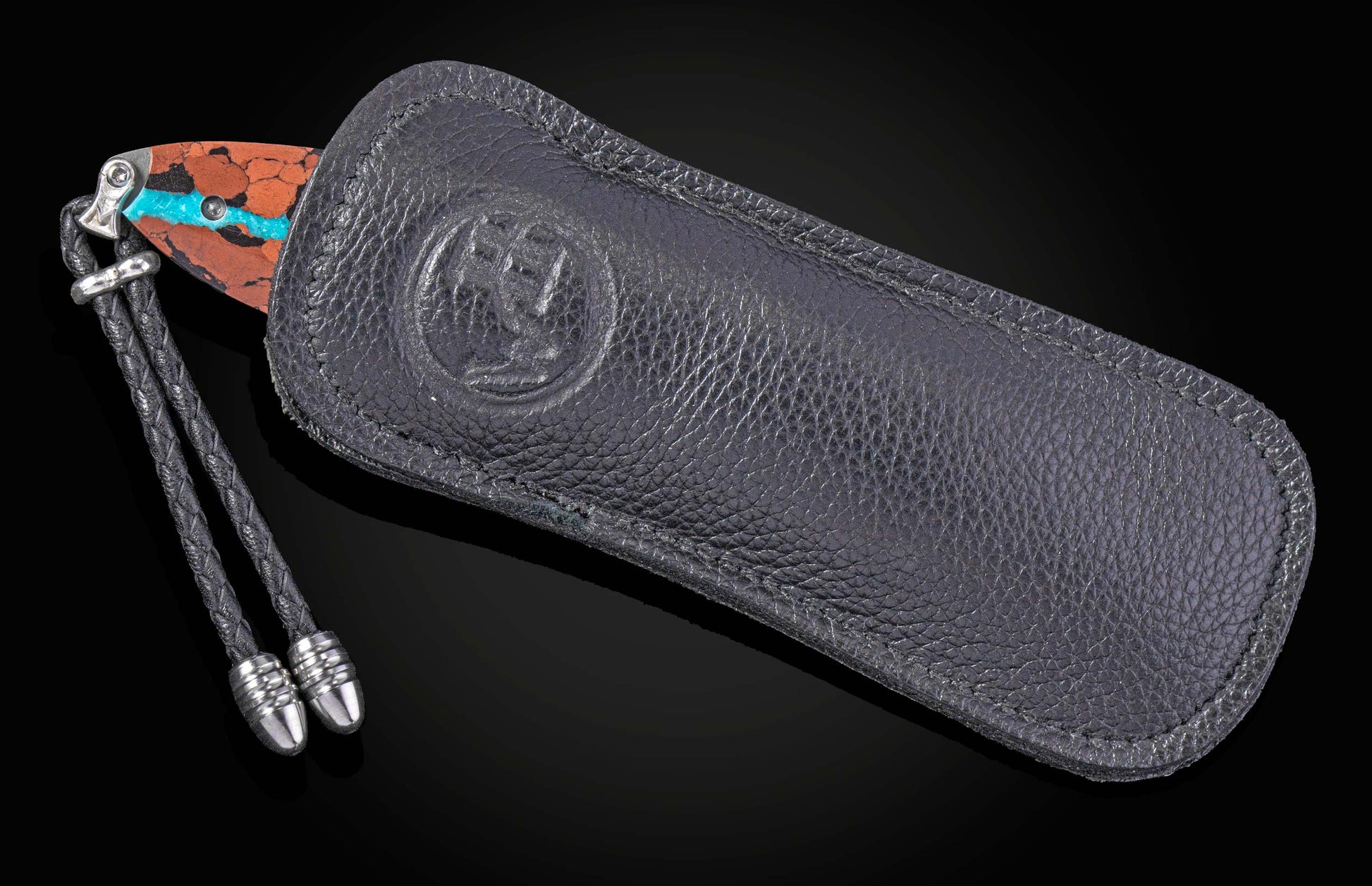 William Henry knife inlaid with vein turquoise and lava rock with damascus blade.