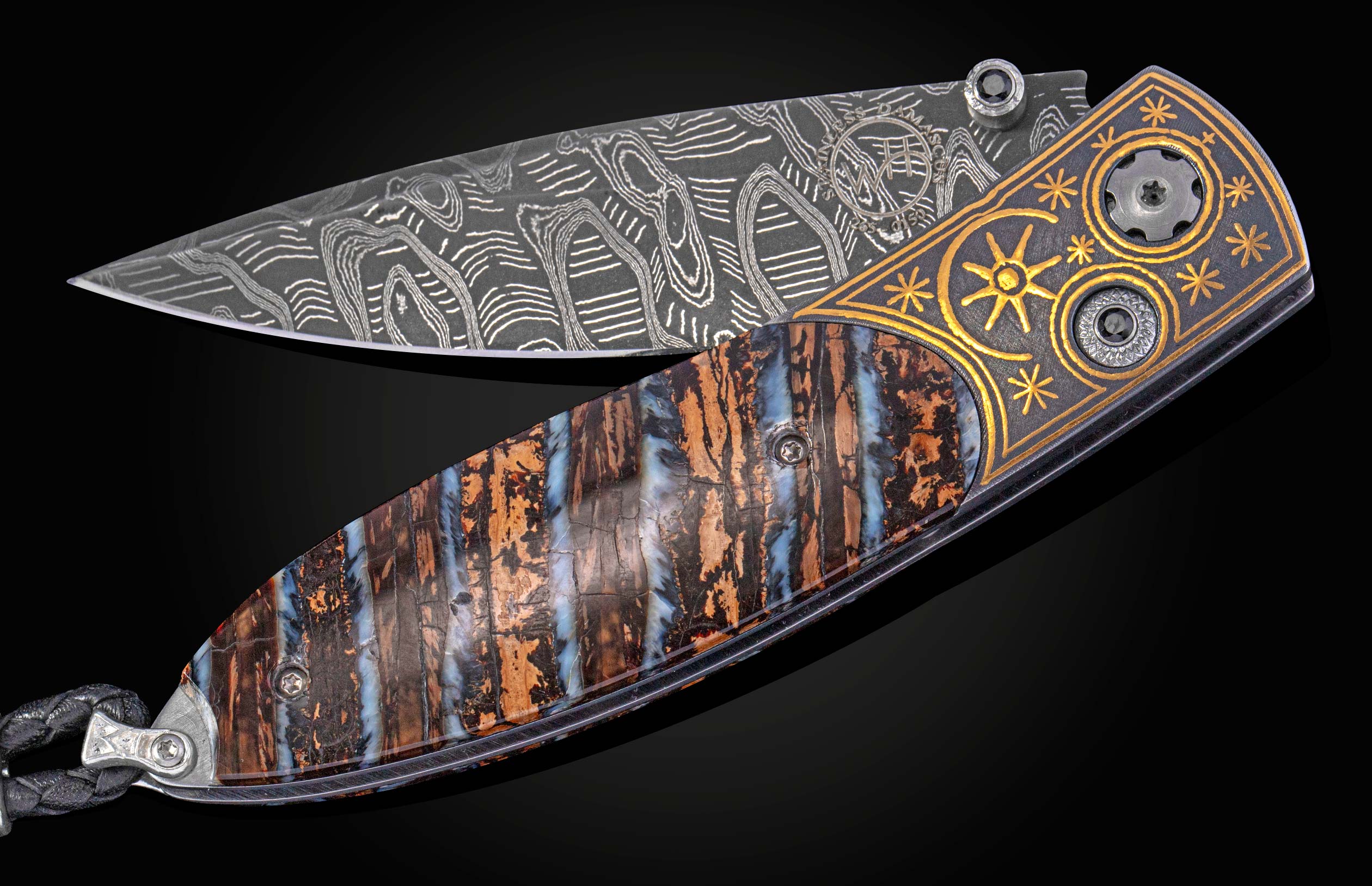 Decorative knife with a fossil mammoth tooth and gold handle on a black background displayed partially open