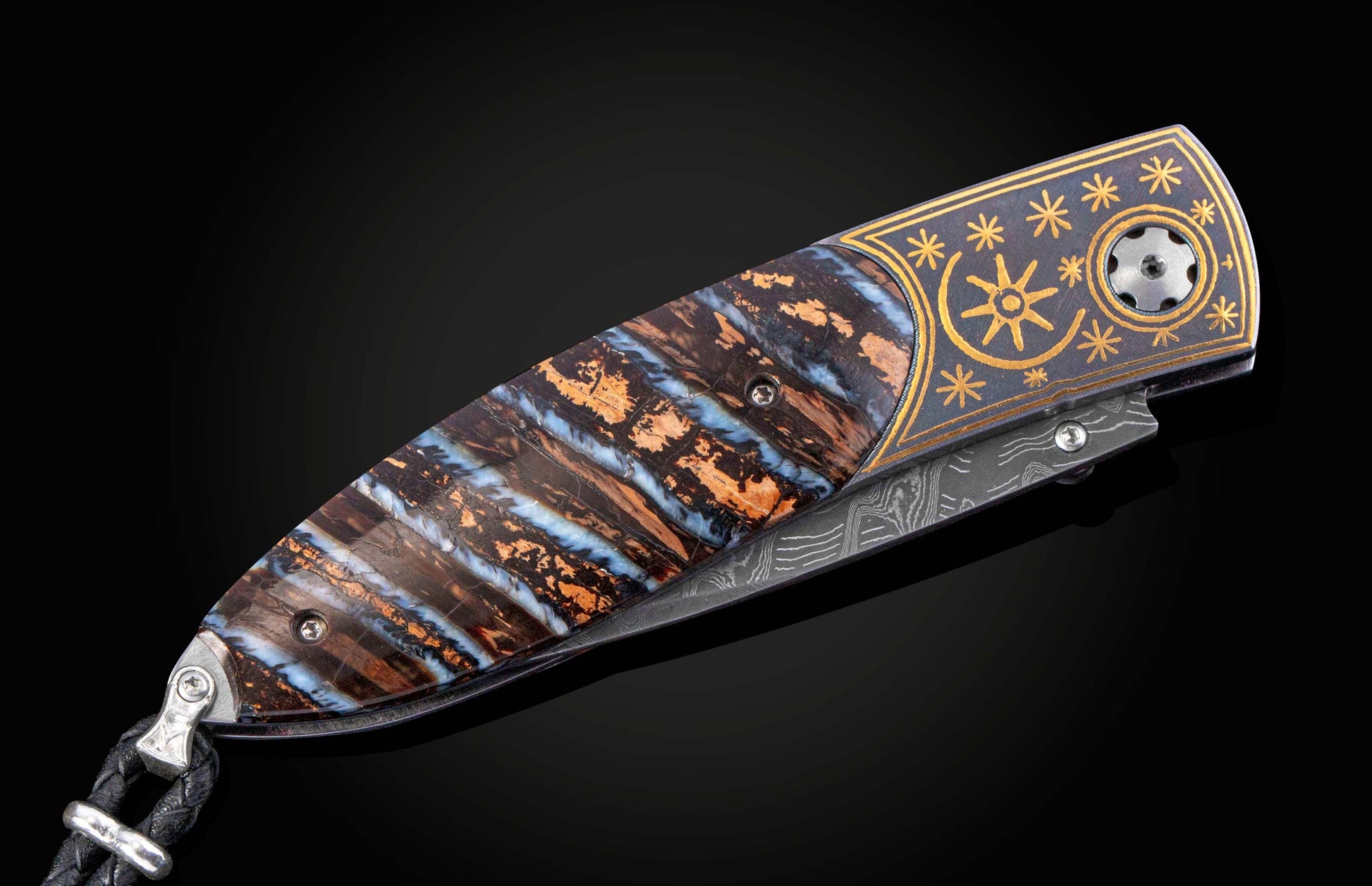 Decorative knife with a fossil mammoth tooth and gold handle on a black background displayed closed