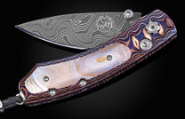 Decorative knife with Damascus blade on a black background
